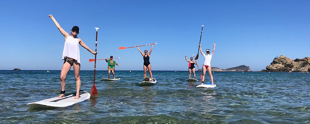 people raising the paddles in sup classes
